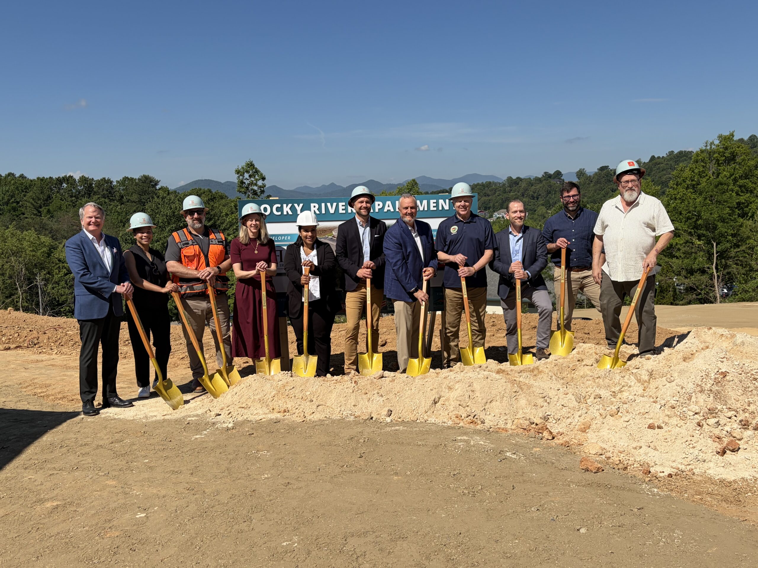 Stakeholders gather for the Rocky River Apartment groundbreaking in Woodfin.