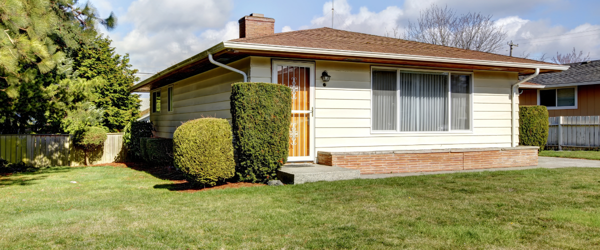 Small home with a front yard.